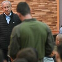Prime Minister Benjamin Netanyahu speaks with soldiers at a base in the West Bank on February 7, 2023. (Koby Gideon/GPO)