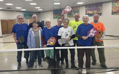 The Kibbutz Tzora pickleball players in their former dining hall pickleball court, January 2023. (Jessica Steinberg/Times of Israel)