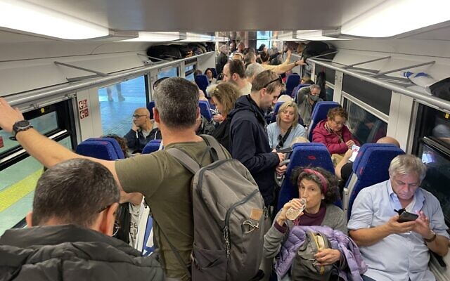 Israelis gather on trains from Tel Aviv to Jerusalem to take part in a mass protest against the government's judicial overhaul, February 20, 2023. (Carrie Keller Lynn/Times of Israel)