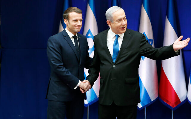 File - Israeli Prime Minister Benjamin Netanyahu shakes hands with French President Emmanuel Macron during their meeting in Jerusalem, January 22, 2020. (Ronen Zvulun/Pool Photo via AP)