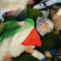 Screen capture from a video published by the Al-Tofula Kindergarten in Beit Awwa in the West Bank, showing children simulating a 'martyr' funeral for one of their number who is killed in a pretend clash with the IDF, February 14, 2023. (Twitter. Used in accordance with Clause 27a of the Copyright Law)