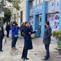 Television and newspaper reporters in Los Angeles interview passersby in the Jewish neighborhood of Pico-Robertson following two shootings that occurred in the area in the previous two days on February 17, 2023. (Asaf Elia-Shalev)