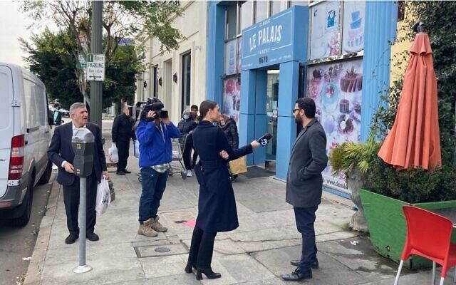 Television and newspaper reporters in Los Angeles interview passersby in the Jewish neighborhood of Pico-Robertson following two shootings that occurred in the area in the previous two days on Feb. 17, 2023. (Asaf Elia-Shalev)
