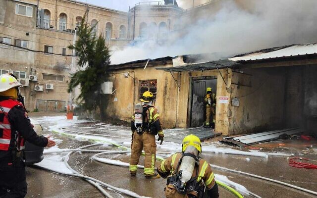 Firefighters work to extinguish a blaze that broke out in a factory next to the Bikur Holim hospital in Jerusalem on February 15, 2023 (Fire Services)
