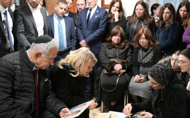 Prime Minister Benjamin Netanyahu and his wife Sara pay a condolence visit to the Paley family, whose two young children were killed in a ramming attack in Jerusalem, February 14, 2023. (Amos Ben Gershom/GPO)