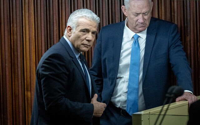 Opposition Leader Yair Lapid, left and National Unity party chief Benny Gantz, right, at the Knesset in Jerusalem, February 20, 2023. (Yonatan Sindel/Flash90)