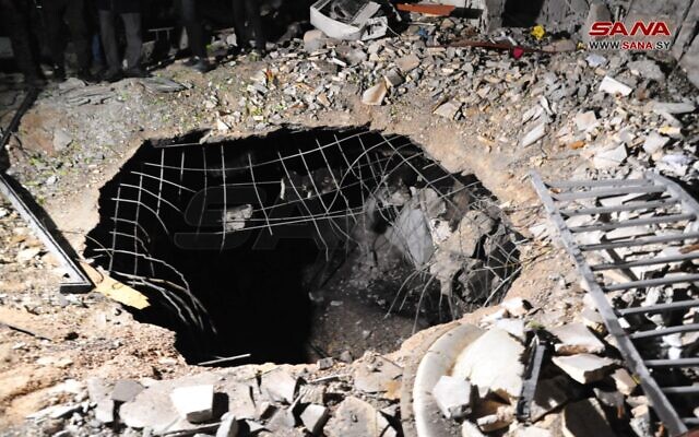 A large hole is seen in the Kafar Sousah neighborhood of Damascus, after an alleged Israeli airstrike on Syria, February 19, 2023. (SANA)