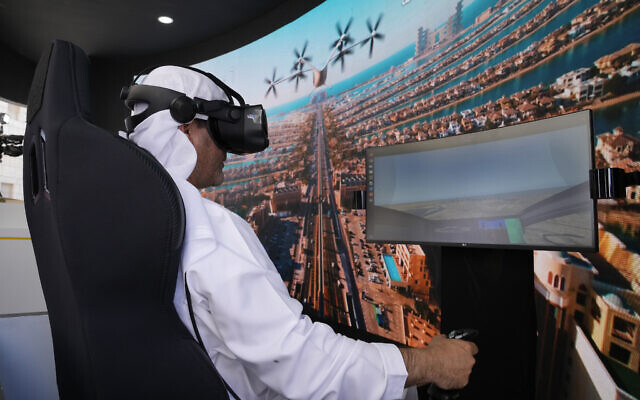 A man experiences a driving simulator of a flying taxi at the Dubai Roads and Transportation Authority's stand during the World Government SummitWLD in Dubai, United Arab Emirates, Monday, Feb 13, 2023. (AP Photo/Kamran Jebreili)