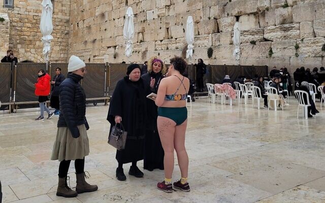 A woman strips down to a bathing suit at the Western Wall in an apparent protest on February 12, 2023. (Social media: Used in accordance with Clause 27a of the Copyright Law)