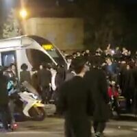 Haredi protesters blocking a light rail train in Jerusalem on February 21, 2023. (screen capture: Twitter/Yair Levy; Used in accordance with Clause 27a of the Copyright Law)