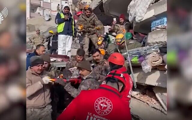 Israeli and local rescue teams carry a 2-year-old boy from the wreckage of a building in southeastern Turkey on February 8, 2023. (Screenshot/IDF)