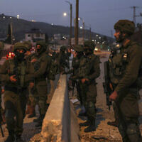 IDF soldiers patrol the main road in Huwara in the West Bank, on February 27, 2023. (Ronaldo Schemidt/AFP)