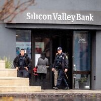 Police officers leave Silicon Valley Bank's headquarters in Santa Clara, California on March 10, 2023. (Noah Berger/AFP)