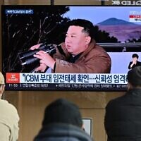 People watch a television news screen showing a picture of North Korea's leader Kim Jong Un witnessing the recent test-firing of a Hwasong-17 intercontinental ballistic missile (ICBM), at a railway station in Seoul on March 17, 2023. (Jung Yeon-je/AFP)