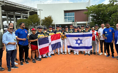 Baseball players from the David Posnack Jewish Day School pose with local Dominican teens at a ceremony March 14, 2023, in Miami. (Jacob Gurvis/ JTA)