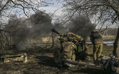 Ukrainian servicemen fire a 105mm Howitzer toward Russian positions, near the city of Bakhmut, on March 4, 2023. (Aris Messinis/AFP)