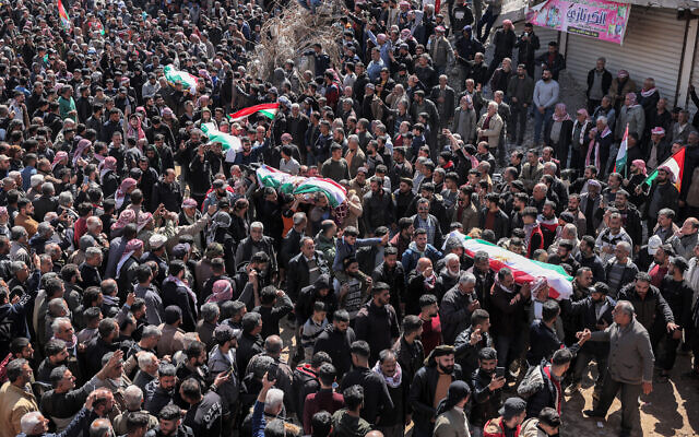Mourners carry the bodies of Kurdish victims killed the previous night by Turkish-backed fighters amid Nowruz New Year celebrations in Jindayris in the rebel-held province of Aleppo, during a mass funeral in Jindayris on March 21, 2023. (Omar Haj Kadour/AFP)