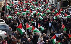 Protesters wave Palestinian flags during a demonstration marking the annual Land Day in the northern Arab-Israeli town of Sakhnin on March 30, 2023 (AHMAD GHARABLI / AFP)