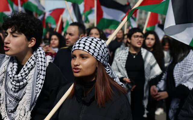 Protesters wave Palestinian flags during a demonstration marking the annual Land Day in the northern Arab-Israeli town of Sakhnin on March 30, 2023.  (Ahmad Gharabli AFP)