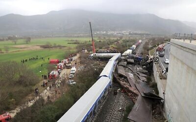 A crane operator, firefighters and rescuers work the scene of a collision in Tempe, about 376 kilometers (235 miles) north of Athens, near Larissa city, Greece, March 1, 2023. (AP/Vaggelis Kousioras)