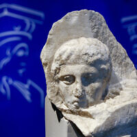 The marble head of a young man, a tiny fragment from the 2,500-year-old sculptured decoration of the Parthenon Temple on the ancient Acropolis, is displayed during a presentation to the press at the new Acropolis Museum in Athens, November 5, 2008. (Thanassis Stavrakis/AP)