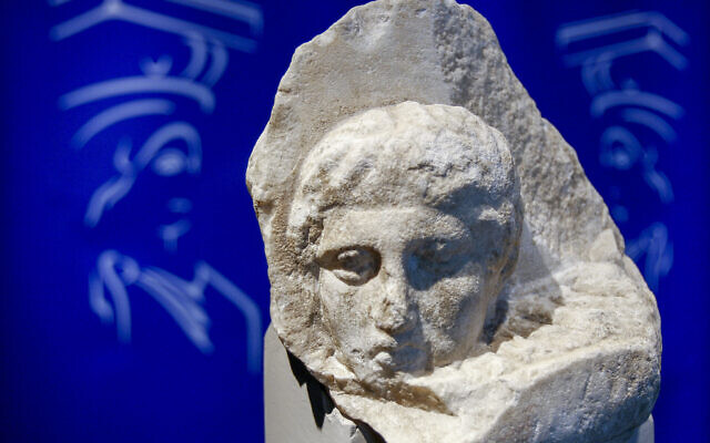 The marble head of a young man, a tiny fragment from the 2,500-year-old sculptured decoration of the Parthenon Temple on the ancient Acropolis, is displayed during a presentation to the press at the new Acropolis Museum in Athens, Nov. 5, 2008. (AP Photo/Thanassis Stavrakis, File)