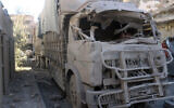 In this photo released by the Syrian official news agency SANA, shows a truck damaged after an explosion hit a building, in Deir el-Zour, Syria, March 8, 2023. (SANA via AP)