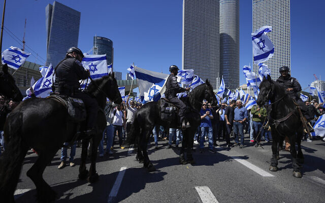 Mounted police are deployed as Israelis block a main road to protest against plans by Prime Minister Benjamin Netanyahu's new government to overhaul the judicial system, in Tel Aviv, March 9, 2023. (AP Photo/Ohad Zwigenberg)
