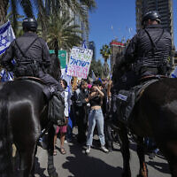 Mounted police are deployed as Israelis block a main road to protest against plans by Prime Minister Benjamin Netanyahu's new government to overhaul the judicial system, in Tel Aviv, Israel, March 9, 2023. (AP Photo/Ohad Zwigenberg)
