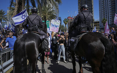 Mounted police are deployed as Israelis block a main road to protest against plans by Prime Minister Benjamin Netanyahu's new government to overhaul the judicial system, in Tel Aviv, Israel, March 9, 2023. (AP Photo/Ohad Zwigenberg)