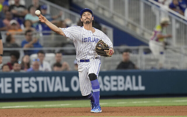 Israel third baseman Garrett Stubbs throws to first base on a hit by Nicaragua catcher Melvin Novoa during the fourth inning of a World Baseball Classic game, March 12, 2023, in Miami. (AP Photo/ Marta Lavandier)