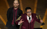 Daniel Scheinert, left, and Daniel Kwan accept the award for best director for "Everything Everywhere All at Once" at the Oscars on Sunday, March 12, 2023, at the Dolby Theatre in Los Angeles. (AP/Chris Pizzello)