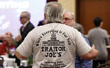 A participant wearing a shirt mocking US President Joe Biden is seen before an Election Conspiracy Forum, March 11, 2023, in Franklin, Tennessee. (AP Photo/Wade Payne)