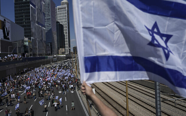 Israelis protest against plans by Prime Minister Benjamin Netanyahu's government to overhaul the judicial system block the main freeway in Tel Aviv, Israel, March 16, 2023. (AP Photo/Oded Balilty)