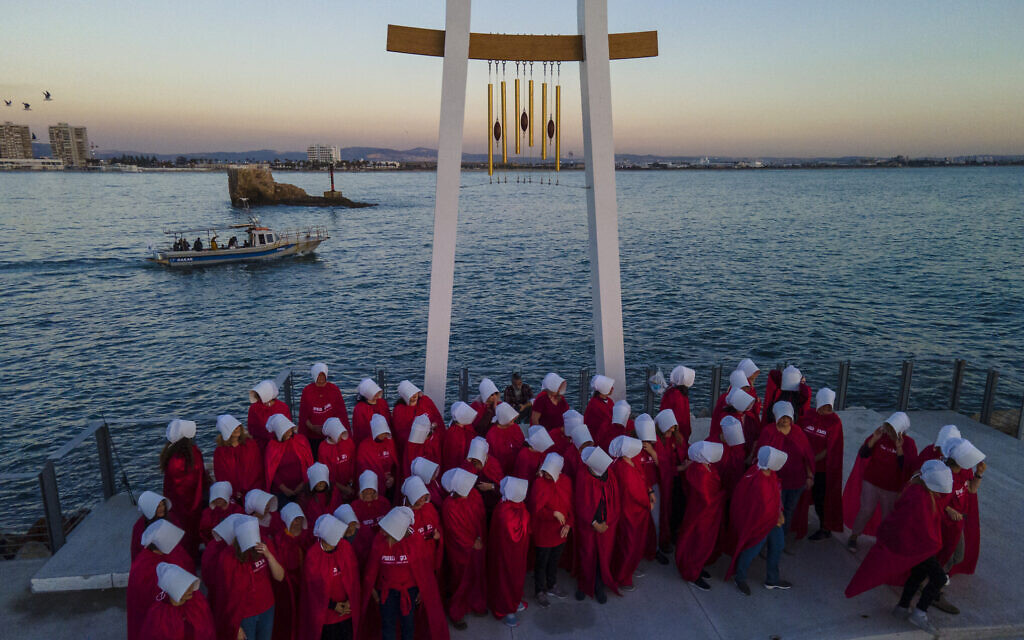 Protesters supporting women's rights dressed as characters from "The Handmaid's Tale" TV series attend a protest against the government's plans to overhaul the judicial system in the old port of Acre, northern Israel, March 16, 2023. (AP/Ariel Schalit)