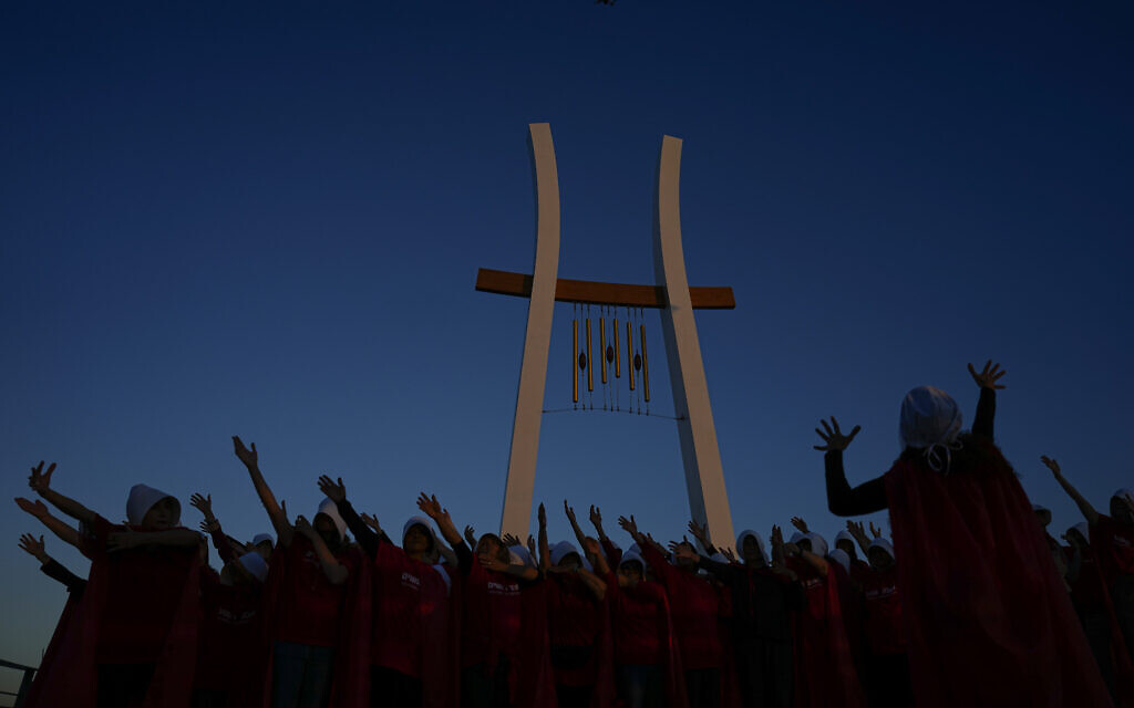 Protesters supporting women's rights dressed as characters from "The Handmaid's Tale" TV series attend a protest against the government's plans to overhaul the judicial system in the old port of Acre, northern Israel, March 16, 2023. (AP/Ariel Schalit)