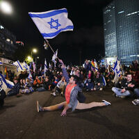 Demonstrators block a highway during protest against plans by Prime Minister Benjamin Netanyahu's government to overhaul the Israel's judicial system, in Tel Aviv, March 18, 2023. (AP Photo/ Ohad Zwigenberg)