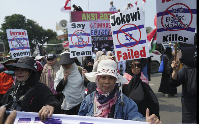 Protesters march during a protest in Jakarta, Indonesia, March 20, 2023. Dozens of conservative Muslims have marched in Indonesia's capital to protest against the Israeli team's participation in the FIFA World Cup Under-20 in Indonesia. (AP Photo/Achmad Ibrahim)