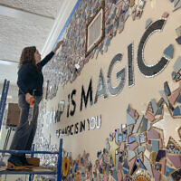 Artist Mia Schon finishes a mural in one of the activity rooms of the Hole In the Wall Gang Camp, March 2, 2023, in Ashford, Connecticut. (AP Photo/Pat Eaton Robb)