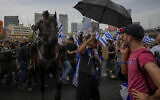 Police use horses to disperse Israelis protesting against plans by Prime Minister Benjamin Netanyahu's government to overhaul the judicial system in Tel Aviv, Israel, Thursday, March 23, 2023to . (AP Photo/Ohad Zwigenberg)