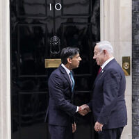 Britain's Prime Minister Rishi Sunak, left, welcomes Prime Minister Benjamin Netanyahu at Downing Street in London, Friday, March 24, 2023.(AP Photo/Alberto Pezzali)