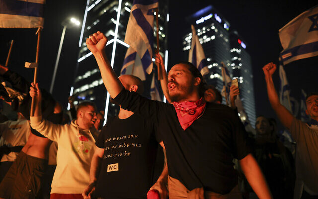Israelis opposed to Prime Minister Benjamin Netanyahu's judicial overhaul plan set up bonfires and block a highway during a protest moments after he fired Defense Minister Yoav Gallant, in Tel Aviv, March 26, 2023. (AP/Oren Ziv)