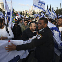 Supporters of the Prime Minister Benjamin Netanyahu's judicial overhaul plan rally near the Knesset in Jerusalem, Monday, March 27, 2023. (AP Photo/Oren Ziv)