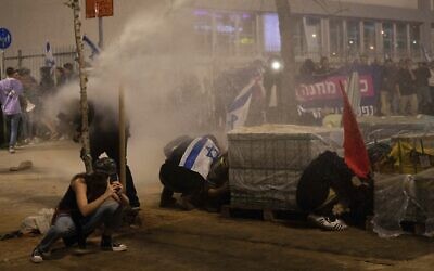 Police use a water cannon to disperse demonstrators blocking a road during protests against plans by Prime Minister Benjamin Netanyahu's government to overhaul the judicial system, in Tel Aviv on March 27, 2023. (AP Photo/Oded Balilty)