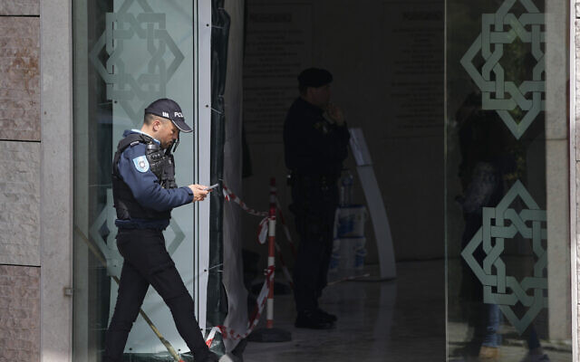 A police officer walks at the entrance of an Ismaili Muslim center in Lisbon, Portugal, Tuesday, March 28, 2023. (AP/Armando Franca)