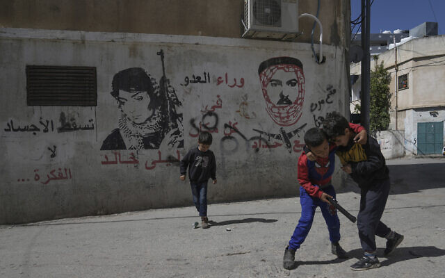 Palestinian schoolchildren play in the street instead of going to school, which is closed due a teachers' strike in the West Bank city of Bethlehem, March 28, 2023. (Mahmoud Illean/AP)