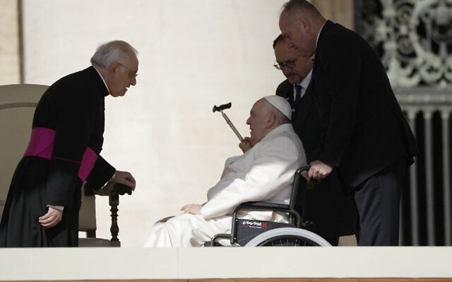 Pope Francis talks with Monsignor Leonardo Sapienza during his weekly general audience in St. Peter's Square, at the Vatican, Wednesday, March 29, 2023. (AP Photo/Alessandra Tarantino)