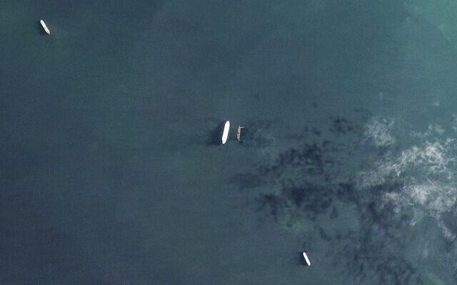 In this satellite photo by Planet Labs PBC, the oil tankers the Oceania, center left, and the Abyss, center right, are seen in the Malacca Strait between Indonesia and Malaysia on March 28, 2023. (Planet Labs PBC via AP)