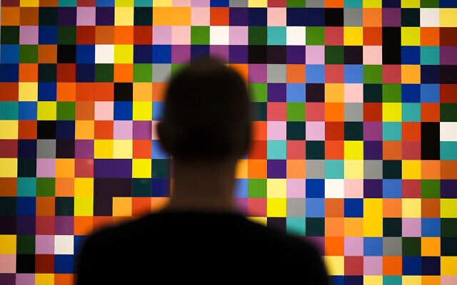 A man looks to a painting '4900 Colours (excerpt)' in a new exhibition with art works of German artist Gerhard Richter at the New National Gallery in Berlin, Germany, Friday, March 31, 2023. (AP Photo/Markus Schreiber)