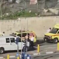Screen capture from video of Red Crescent ambulances transferring three children who were critically injured in a traffic accident in East Jerusalem to Magen David Adom ambulances at a checkpoint, March 2, 2023. (Twitter. Used in accordance with Clause 27a of the Copyright Law)